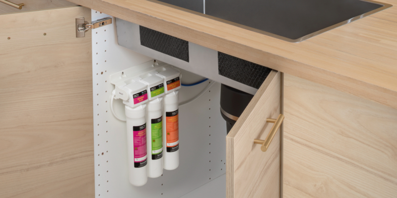 Brondell Coral Three-Stage Under Sink Water Filtration System installed in a modern kitchen cabinet.