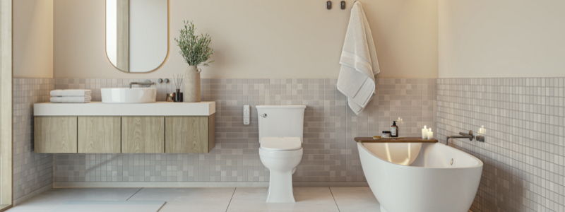 Modern light wood bathroom with gold accents featuring the Brondell Swash Eco Thinline T66 Luxury Bidet TOilet Seat installed next to a large soaking tub with aromatherapy candles.