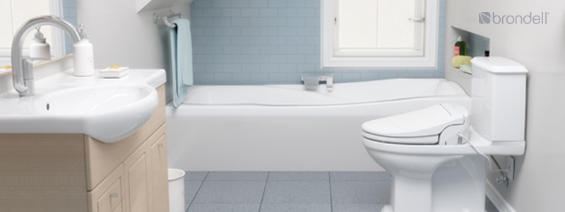 Brondell Swash 1400 Luxury Bidet seat installed in a clean bathroom with blue tiles and light wood cabinet